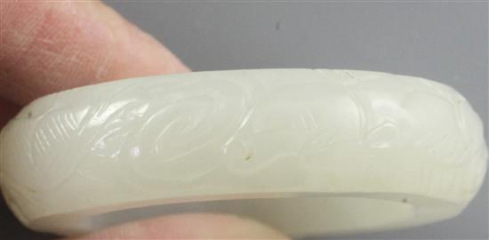 A Chinese white jade bangle or ring, diameter 5.7cm